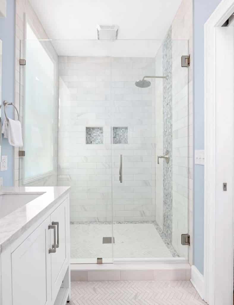 Newly updated walk-in shower with glass door.