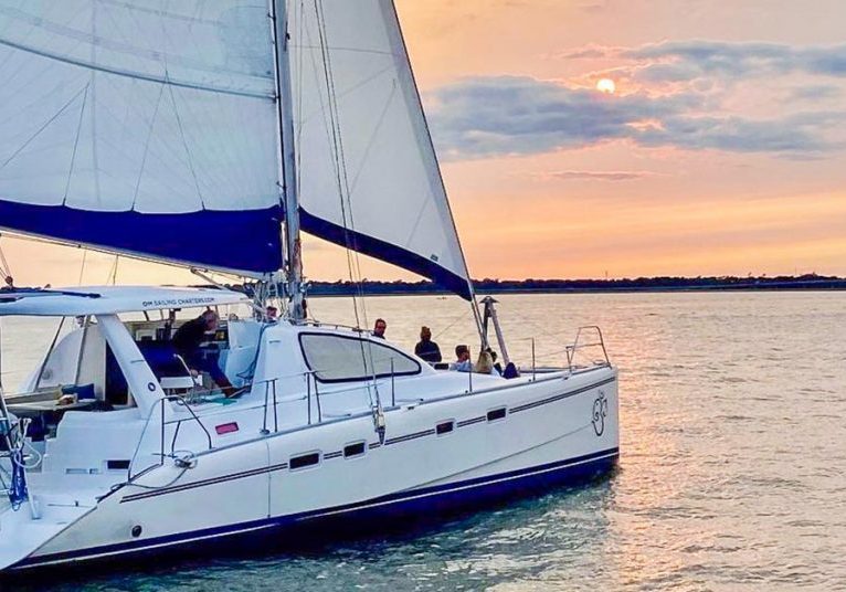 A catamaran on the Charleston Harbor enjoying the sunset.