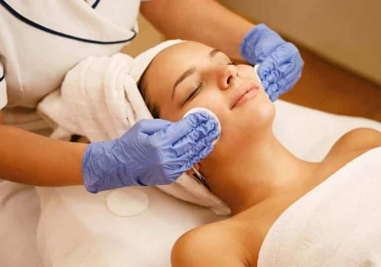 High angle view of young woman having facial treatment at beauty spa.